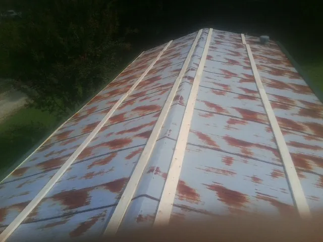 Rusted metal roof panels with new wood purlins before replacement — Storm Damage Roof Repair in Beverly by Roofing Brothers